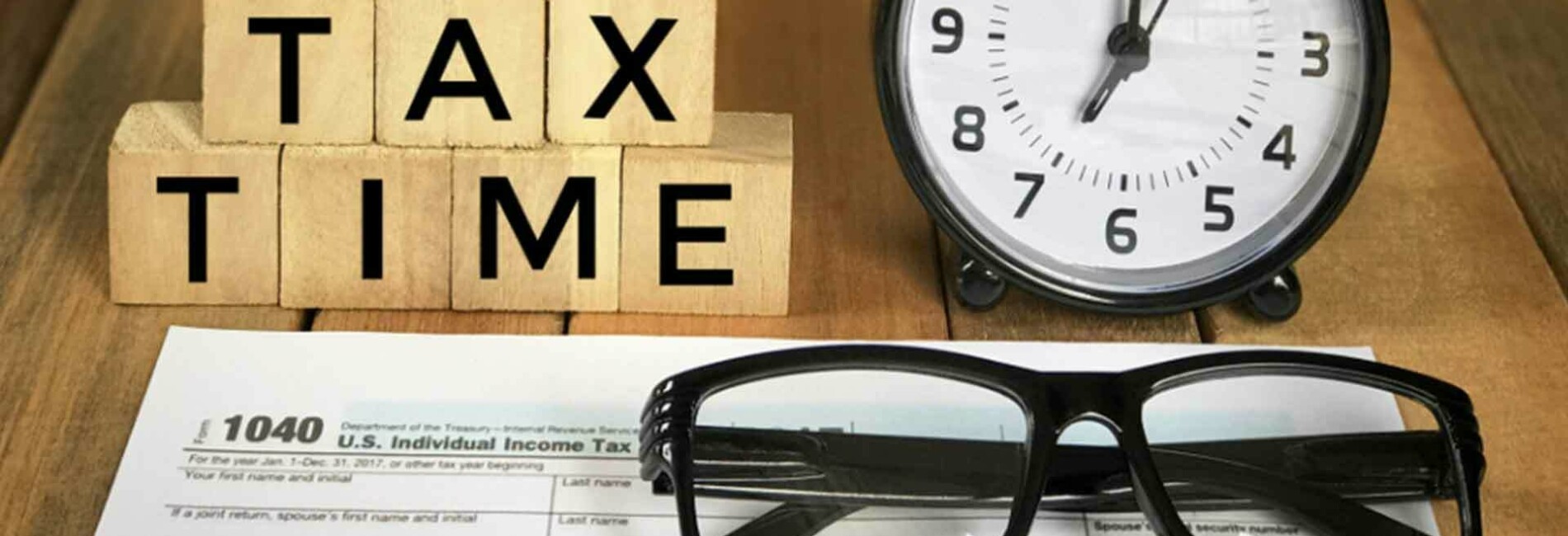 Tax form clock and reading glasses