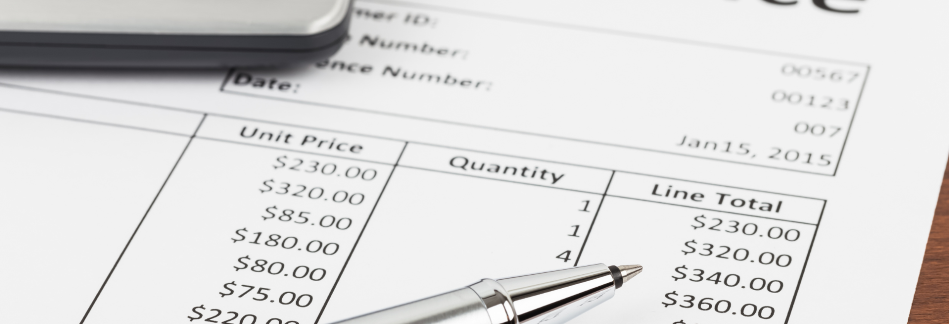 Invoice with pen and calculator on paper