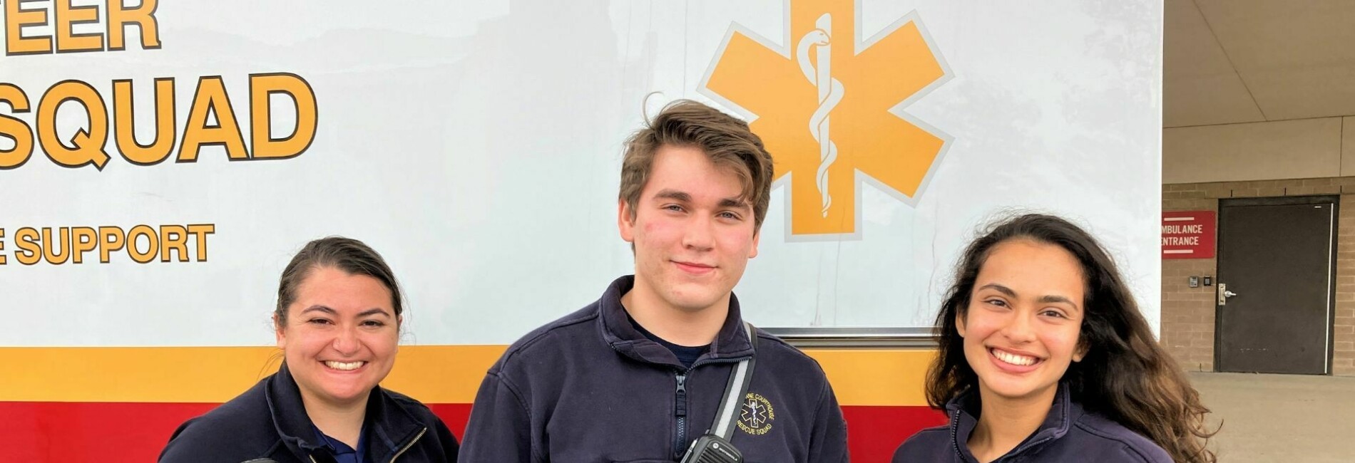 Volunteer paramedics in front of ambulance