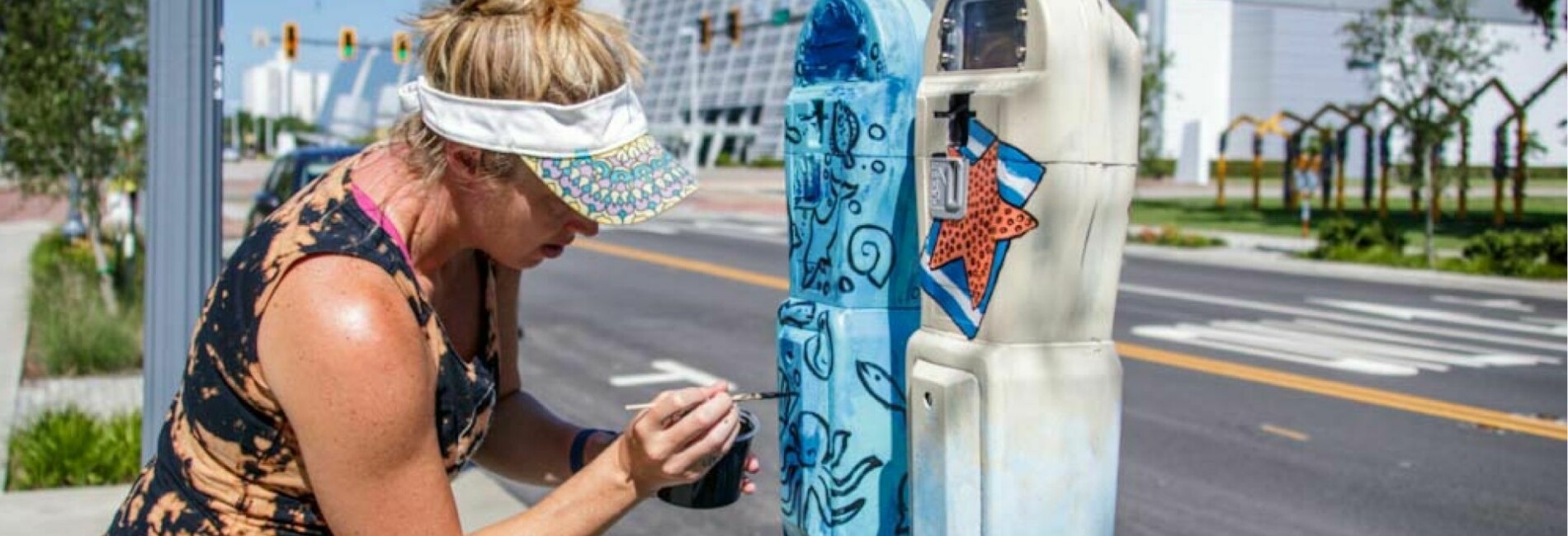 Artist painting parking meter