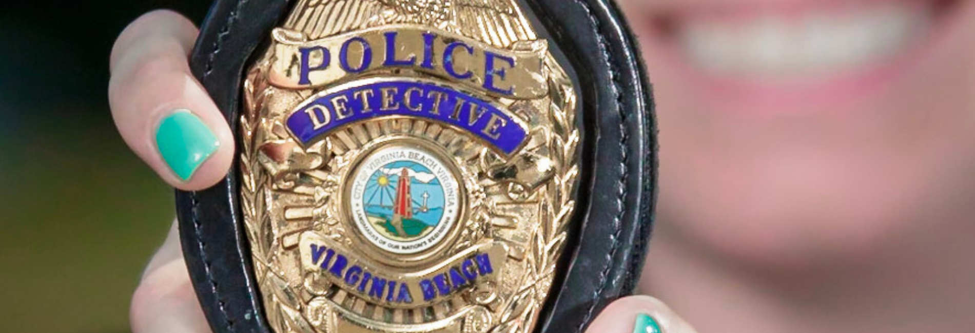 Close up of VBPD detective badge being held by detective