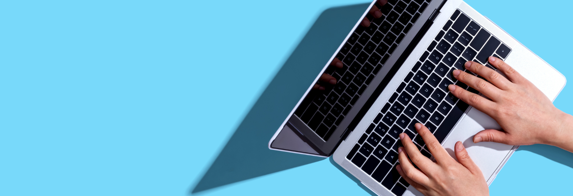 Close up of hands typing on laptop keyboard